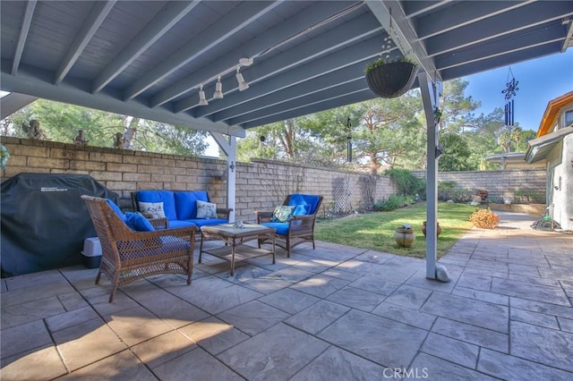 view of patio with an outdoor living space, a fenced backyard, and area for grilling