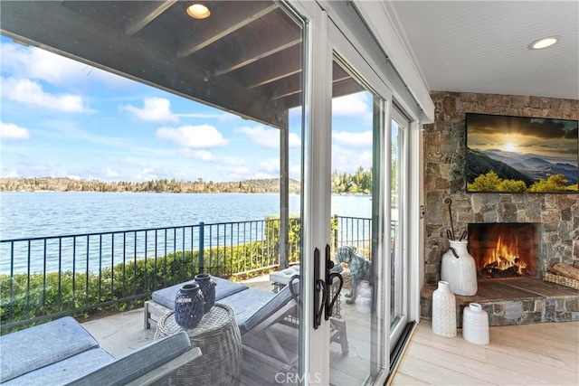 balcony with an outdoor stone fireplace