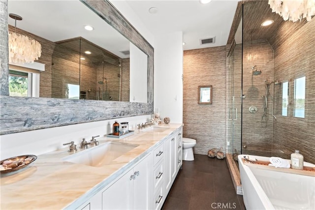 bathroom with a sink, a soaking tub, a shower stall, and double vanity