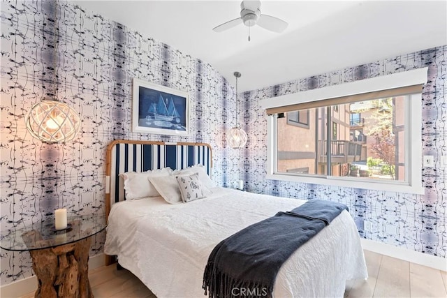 bedroom featuring baseboards, ceiling fan, and wallpapered walls