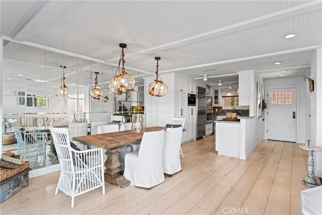 dining room with recessed lighting, a chandelier, and light wood-type flooring