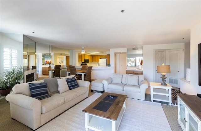 living room featuring light colored carpet and visible vents