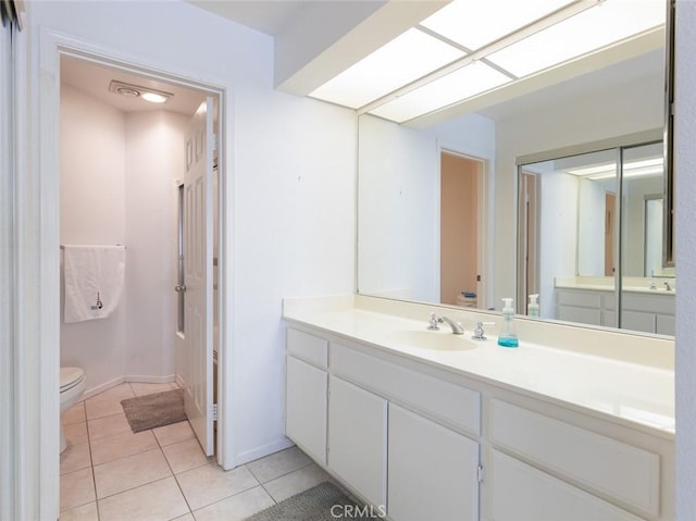 full bathroom with toilet, tile patterned flooring, and vanity