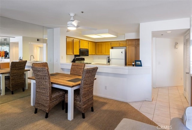 dining area featuring visible vents, a ceiling fan, light tile patterned flooring, and light carpet