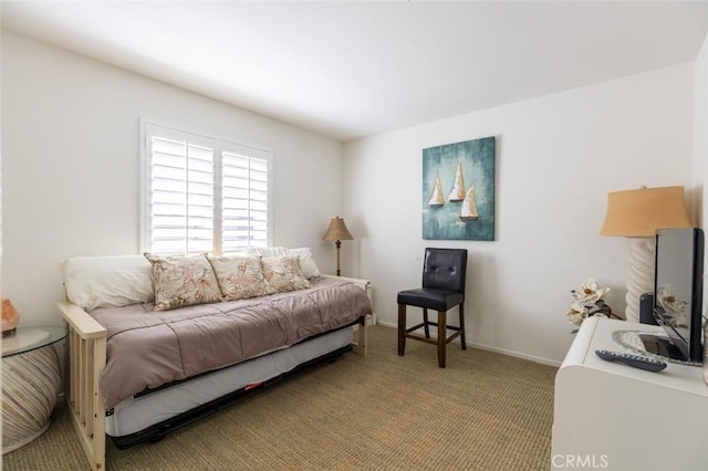bedroom featuring baseboards and light carpet
