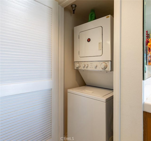 washroom with laundry area and stacked washer / dryer