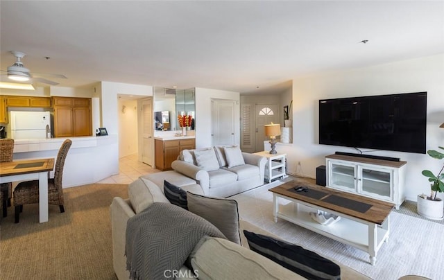 living room with light carpet, a ceiling fan, and visible vents