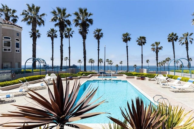 pool with fence and a patio area