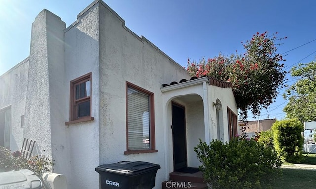 view of side of property featuring stucco siding