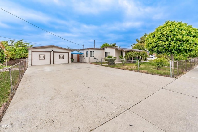 view of front of house with a garage and fence
