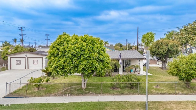 view of front of house featuring a fenced front yard, a front yard, and a detached garage