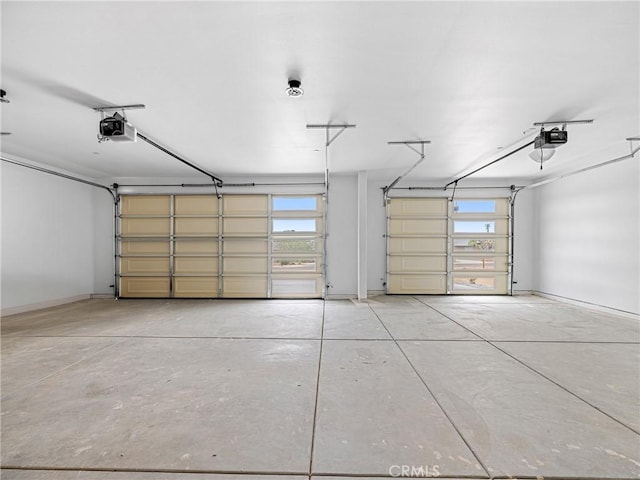 garage with baseboards and a garage door opener