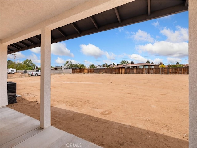 view of yard featuring a fenced backyard and central AC