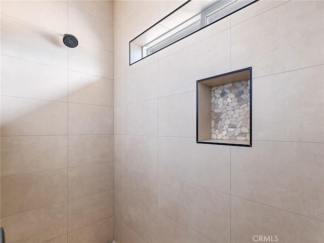 full bath with a tile shower