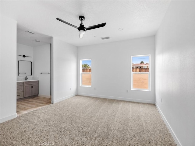 unfurnished bedroom featuring carpet floors, baseboards, and visible vents