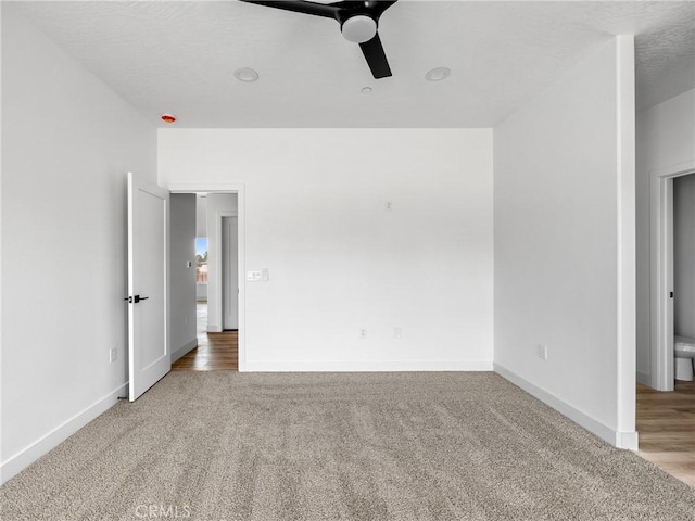 empty room featuring carpet flooring, ceiling fan, and baseboards