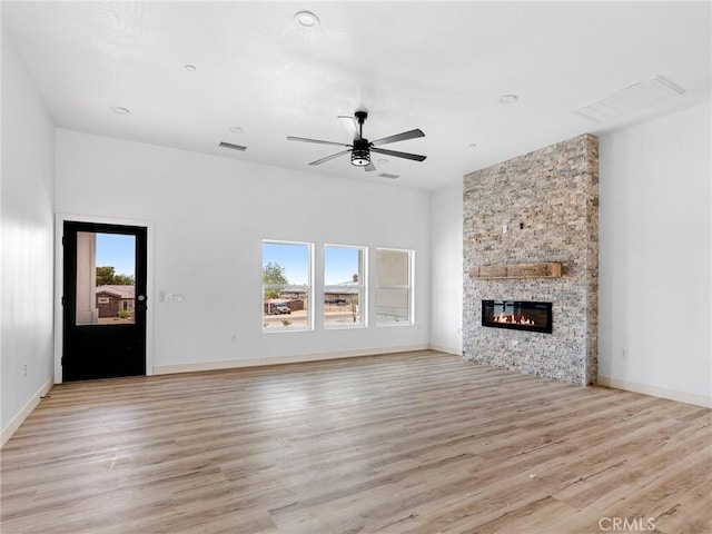 unfurnished living room with visible vents, light wood-style flooring, and plenty of natural light