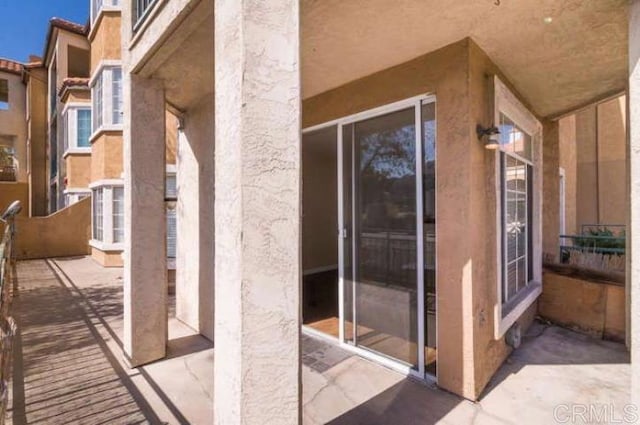 property entrance with stucco siding