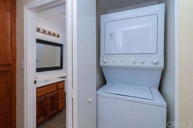 laundry room with stacked washer and dryer and laundry area