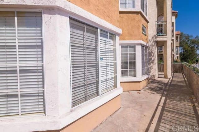 exterior space featuring fence and stucco siding