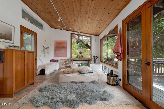 sunroom with wooden ceiling, track lighting, and french doors