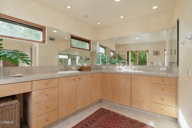 bathroom featuring recessed lighting and vanity