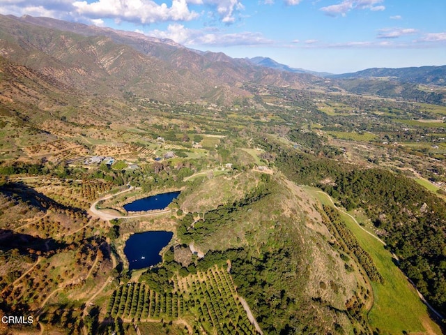 aerial view of property and surrounding area with a water and mountain view