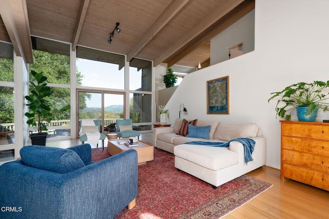 living room with beamed ceiling, expansive windows, wood finished floors, high vaulted ceiling, and wooden ceiling