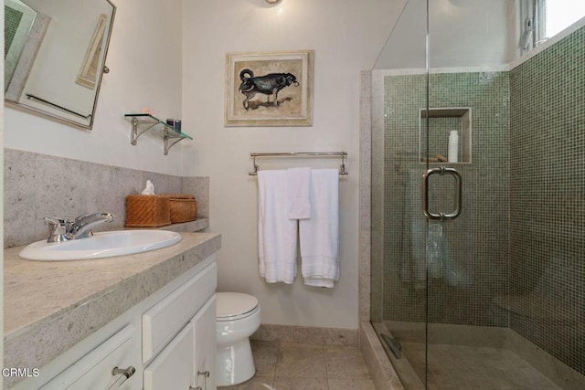 full bathroom featuring a stall shower, tile patterned flooring, vanity, and toilet