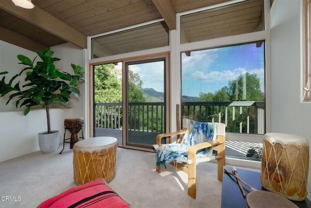 sunroom featuring beam ceiling