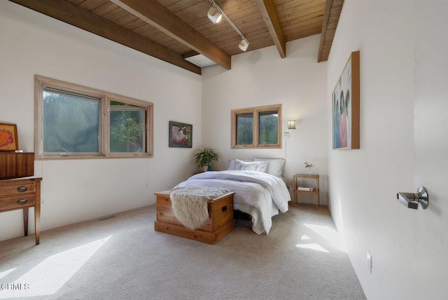 bedroom with wooden ceiling, beamed ceiling, carpet flooring, and track lighting