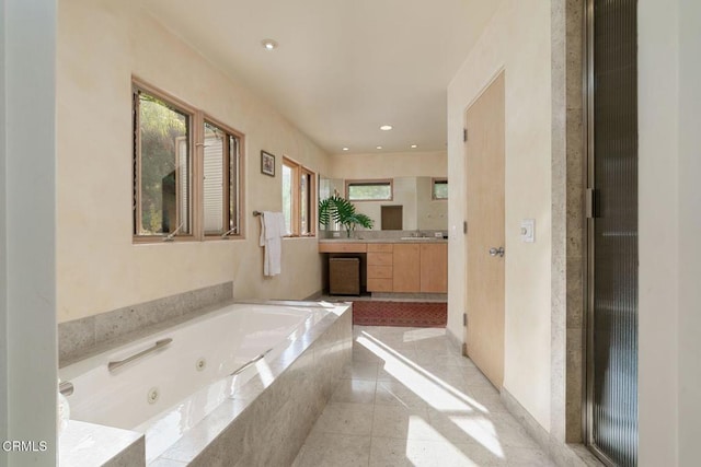 bathroom with vanity and a whirlpool tub