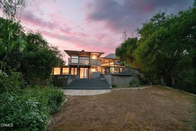 back of house with stairway and a deck