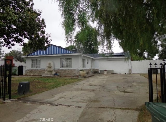 8156 Cornwall Ave, Rancho Cucamonga, CA 91739 - view of front of house featuring stucco siding, concrete driveway, stone siding, and roof mounted solar panels