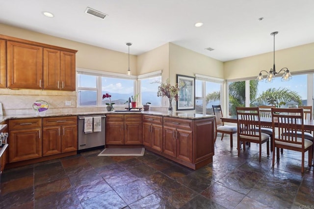 944 Rainbow Crest Rd, Fallbrook, CA 92028 - kitchen with dishwasher, stone tile floors, brown cabinetry, hanging light fixtures, and recessed lighting