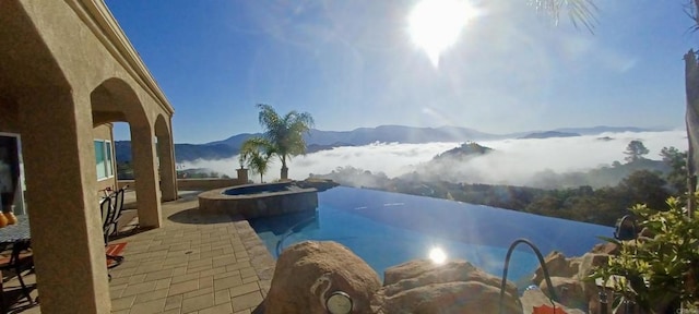 944 Rainbow Crest Rd, Fallbrook, CA 92028 - view of pool with a mountain view, a pool with connected hot tub, and a patio area