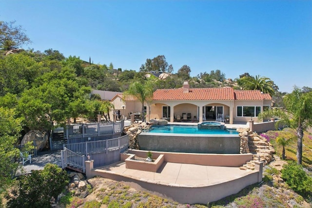 944 Rainbow Crest Rd, Fallbrook, CA 92028 - rear view of house featuring a tiled roof, a patio, a chimney, stucco siding, and a pool with connected hot tub