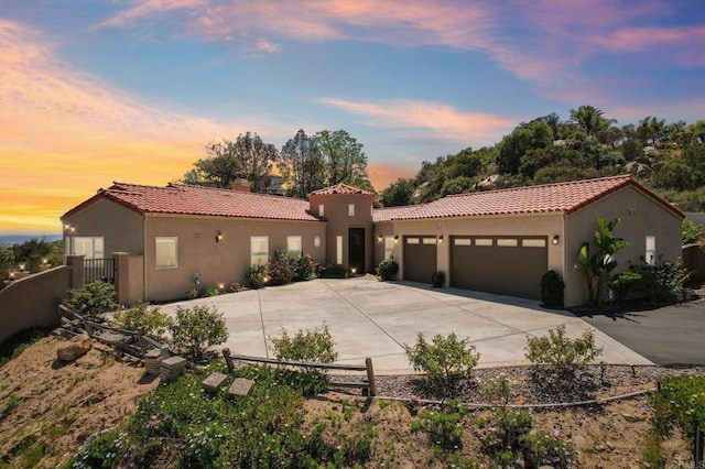 944 Rainbow Crest Rd, Fallbrook, CA 92028 - mediterranean / spanish house featuring a tile roof, concrete driveway, a garage, and stucco siding