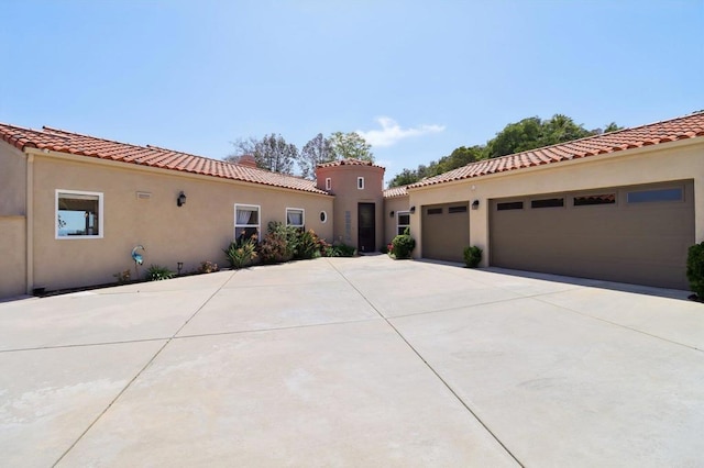 944 Rainbow Crest Rd, Fallbrook, CA 92028 - mediterranean / spanish house with driveway, stucco siding, a tile roof, and a garage