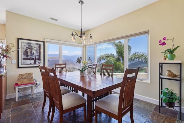 944 Rainbow Crest Rd, Fallbrook, CA 92028 - dining space with stone tile flooring, baseboards, a chandelier, and a mountain view