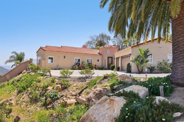 944 Rainbow Crest Rd, Fallbrook, CA 92028 - back of house featuring stucco siding, a tiled roof, a garage, a chimney, and concrete driveway