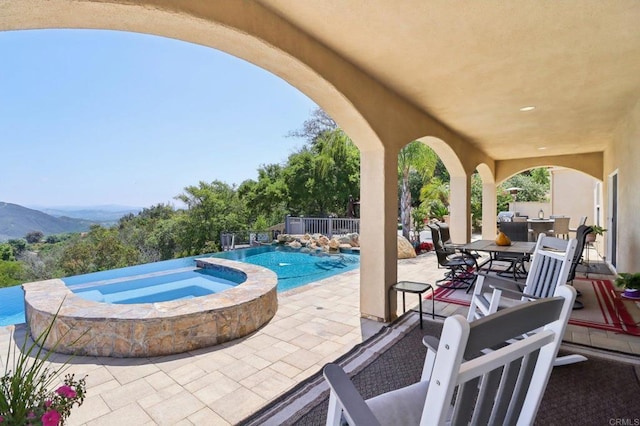 944 Rainbow Crest Rd, Fallbrook, CA 92028 - view of patio featuring outdoor dining space, a pool with connected hot tub, and a mountain view