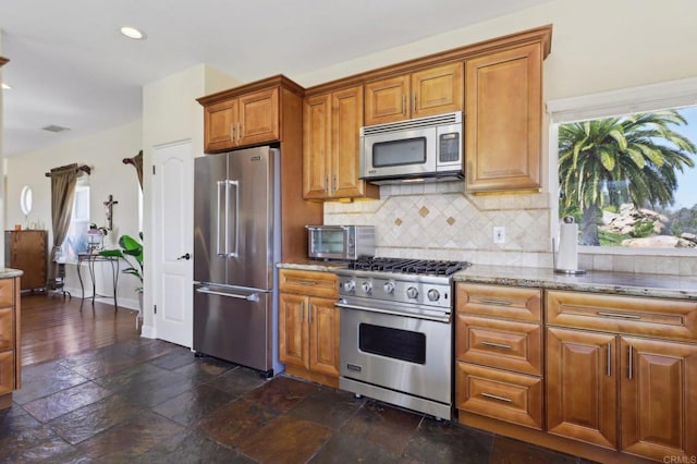 944 Rainbow Crest Rd, Fallbrook, CA 92028 - kitchen featuring premium appliances, plenty of natural light, light stone counters, brown cabinets, and recessed lighting
