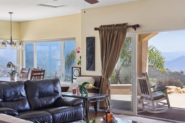 944 Rainbow Crest Rd, Fallbrook, CA 92028 - living area with plenty of natural light, wood finished floors, a chandelier, and a ceiling fan