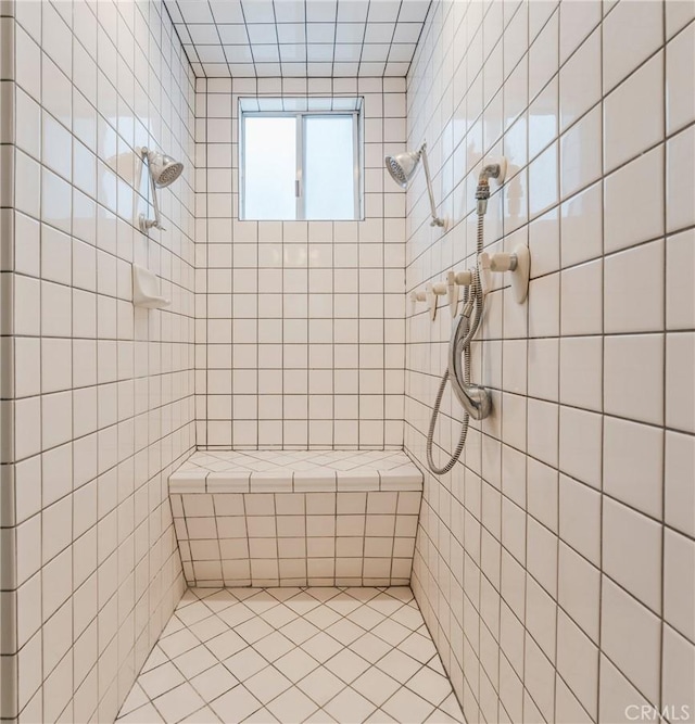 full bathroom with tile walls, tile patterned flooring, and tiled shower
