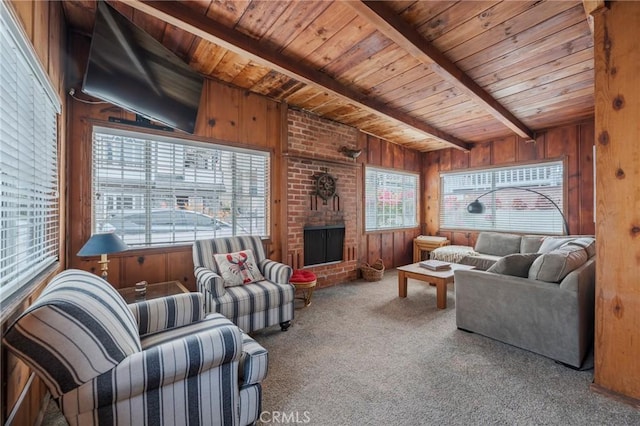 carpeted living room featuring wooden ceiling, wood walls, a brick fireplace, and plenty of natural light