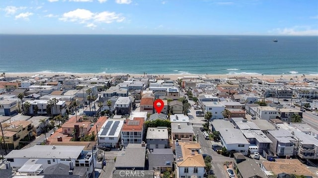 drone / aerial view featuring a residential view, a beach view, and a water view