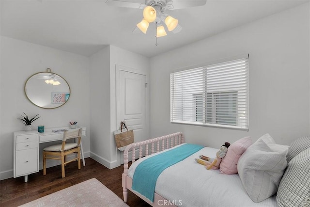 bedroom featuring baseboards, a ceiling fan, and wood finished floors