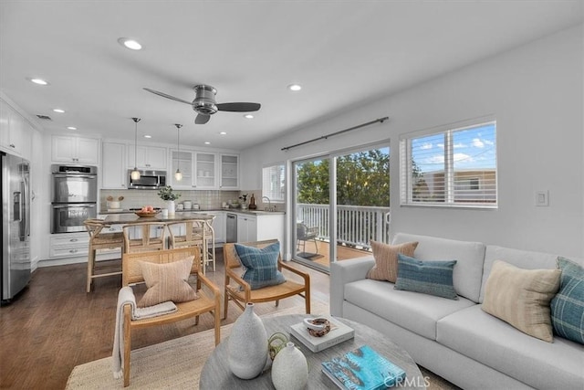 living area featuring dark wood finished floors, ceiling fan, recessed lighting, and visible vents