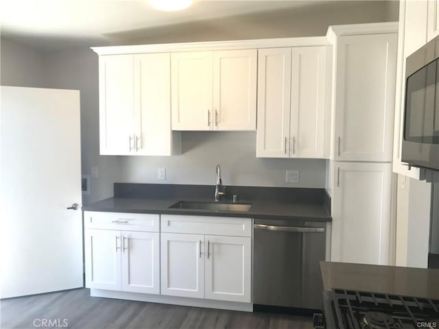 539 E 223rd St, Carson, CA 90745 - kitchen with stainless steel appliances, dark countertops, white cabinets, and dark wood-style floors